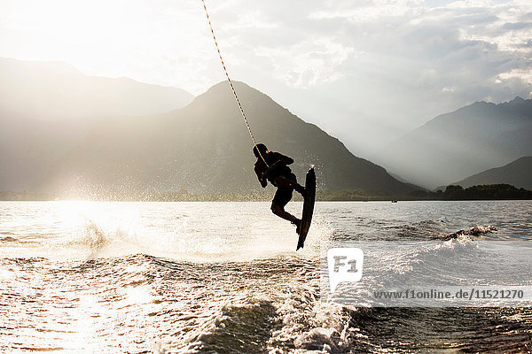 Silhouette of waterskier waterskiing  Maggiore lake  Verbania  Piedmont  Italy