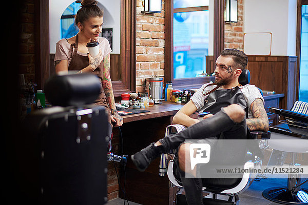 Hairdressers taking a break in barbershop