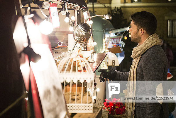Man on a Christmas market at night