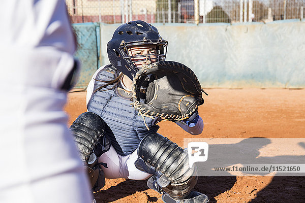 Female catcher ready to catch the ball during a baseball game