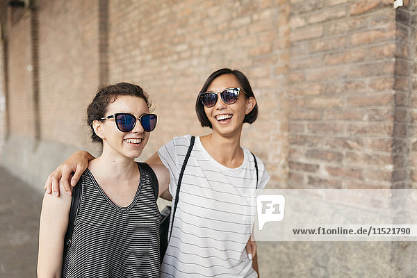 Portrait of two best friends with sunglasses having fun