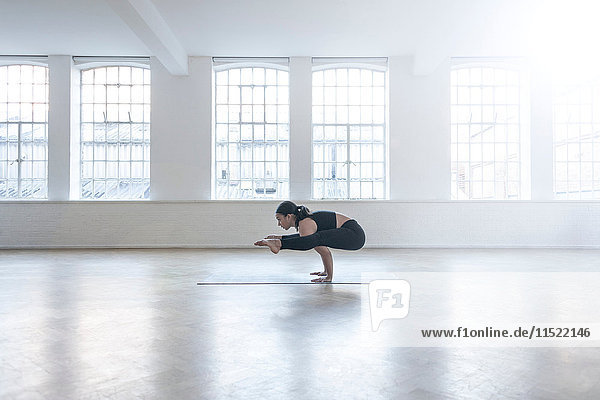 Woman in dance studio in yoga position