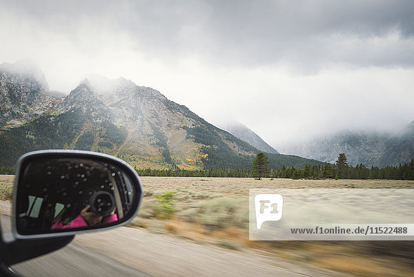 USA  Wyoming  Grand Teton National Park  wing mirror with mirror image of woman taking picture