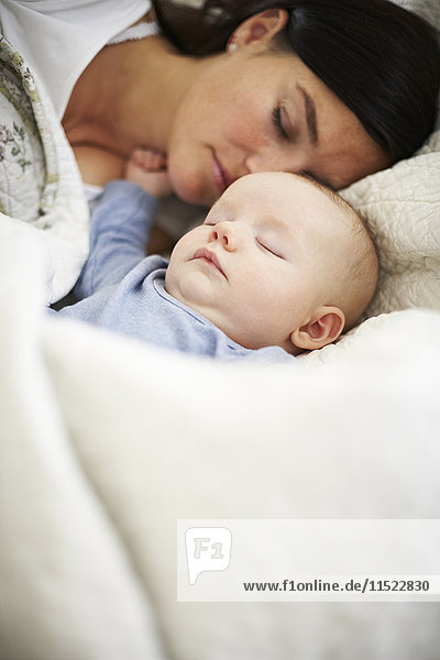 Mother and baby sleeping in bed