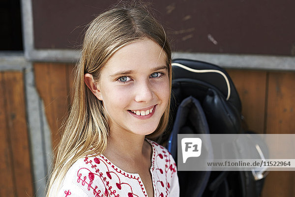 Portrait of smiling girl on horse farm
