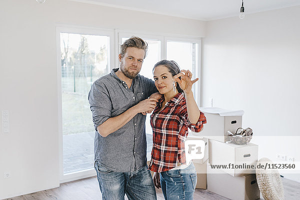 Couple moving house  woman holding keys of new home