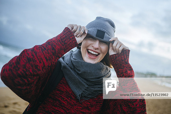 Happy young woman on the beach in winter
