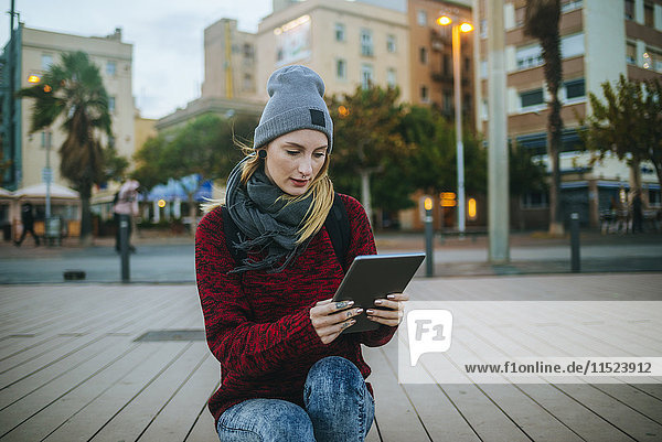 Spanien  Barcelona  junge Frau mit einer Tablette im Freien im Winter