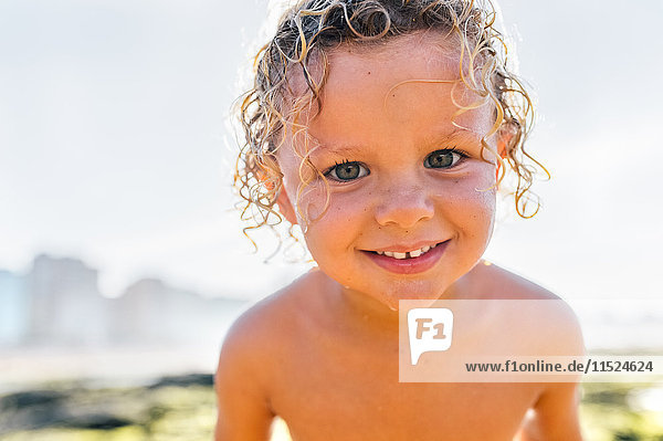 Portrait of wet little boy on the beach
