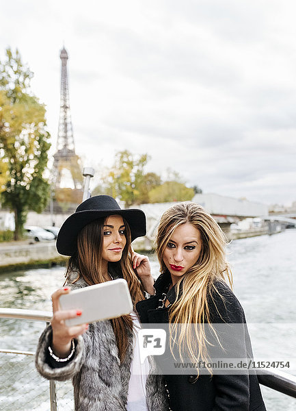 France  Paris  tourists taking selfie with cell phone