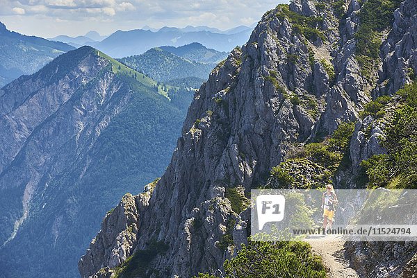 Deutschland  Bayern  Junge Frau beim Laufen in den Bergen