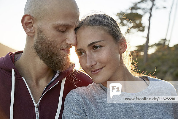 Relaxed young couple in love at backlight