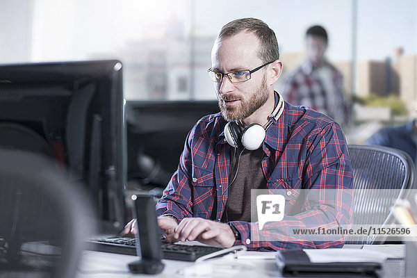 Man working on computer at desk in office