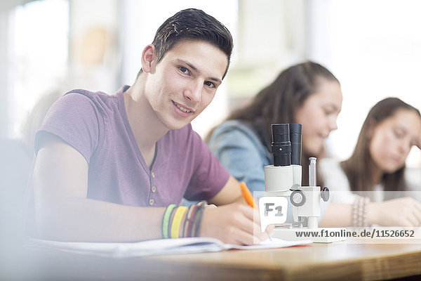 Portrait of smiling science student in class