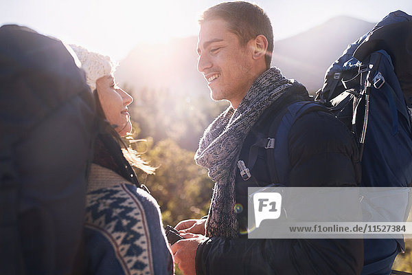 Young couple with backpacks hiking