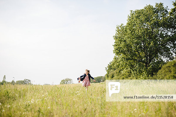 Girl running in meadow