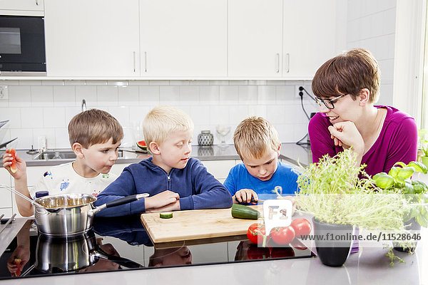 Boys preparing food in kitchen