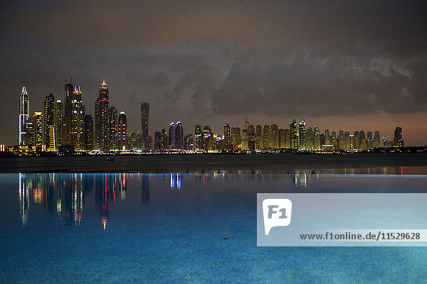 United Arab Emirates  Dubai  Oceana swimming pool  the Palm Jumeirah and the skyscraper skyline at night