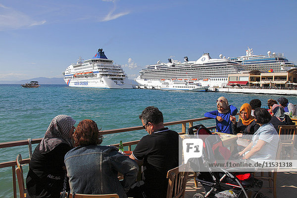 Turkey  province of Aydin  Kusadasi  cafe terrrace and cruise ship