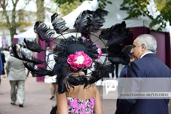 France  Paris 16th district  Longchamp Racecourse  Qatar Prix de l'Arc de Triomphe on October 4th and 5th 2014  closeup of an elegant and fashionable woman wearing a hat seen from behind