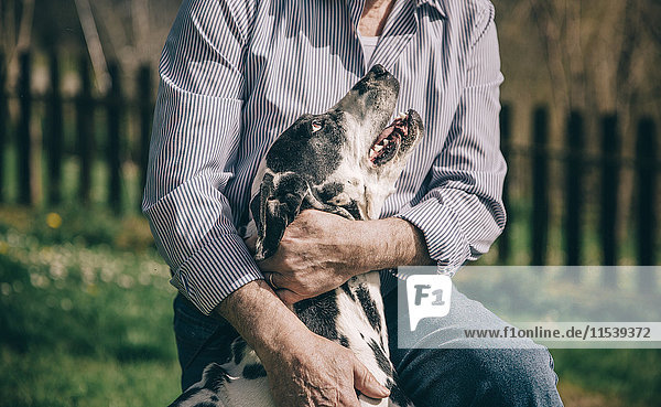 Senior man hugging his Dalmatian dog