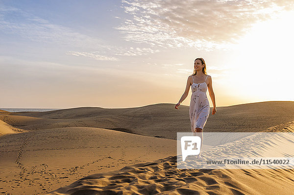 Woman walking on dune