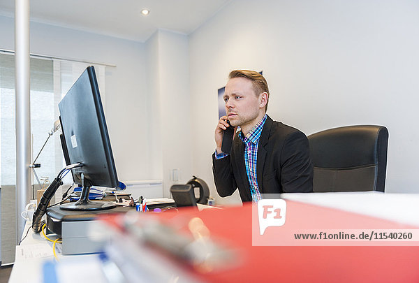 Manager working in office  talking on the phone