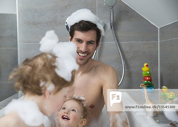 Vater hat Spaß mit Söhnen in der Badewanne