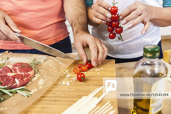 Slicing tomatoes on chopping board