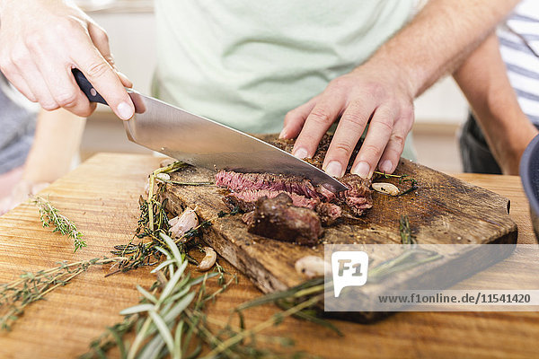 Cutting steak on chopping board