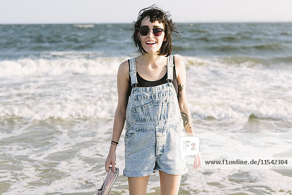 USA  New York  Coney Island  portrait of happy young woman on the shoreline