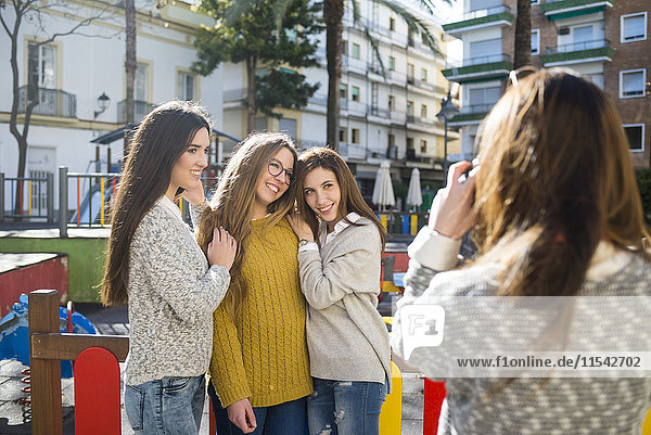 Young woman taking a picture of her friends