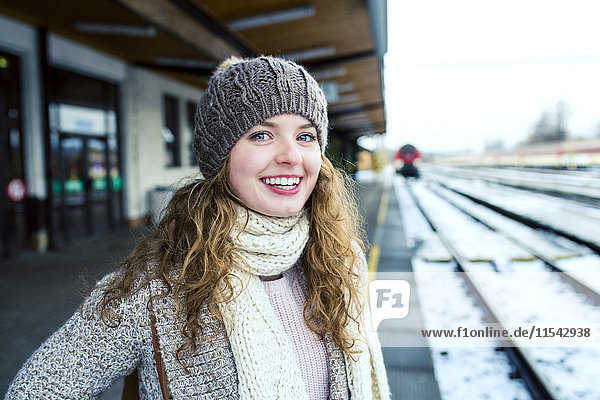 Portrait of smiling teenage girl on station platform