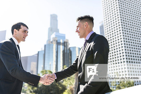 USA  Los Angeles  two businessmen shaking hands