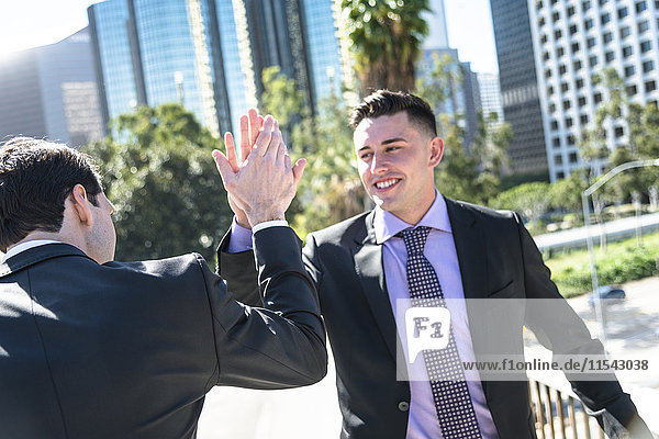USA  Los Angeles  two businessmen high fiving