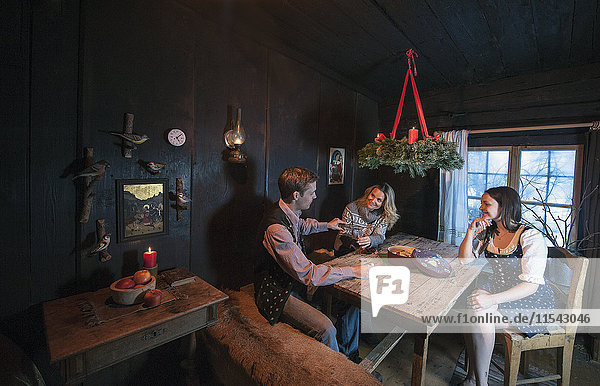 Three friends spending time together in a farmhouse room at Advent