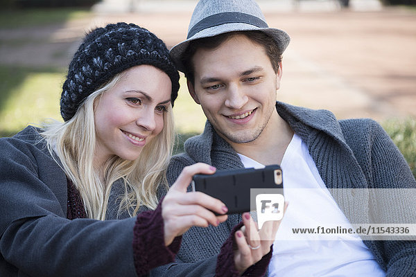 Porträt eines verliebten Paares  das sich selbst mit dem Smartphone fotografiert.