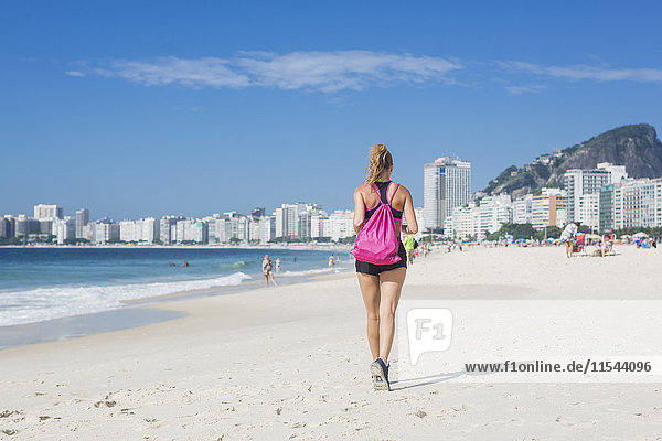 Brazil  Rio de Janeiro  back view of woman jogging on the beach