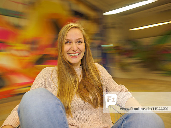 Young woman spinning in shopping cart