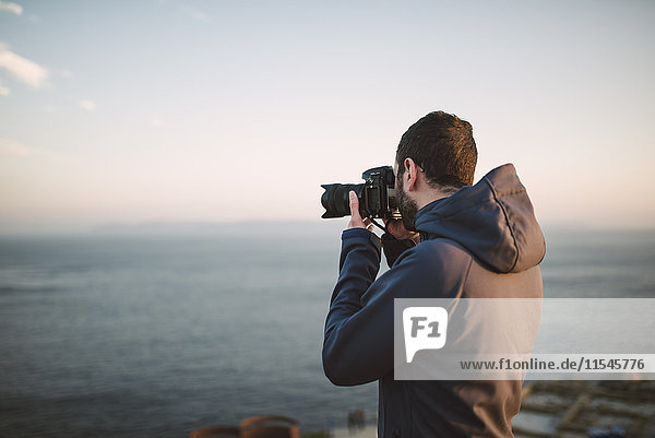 Man taking photos of the sea