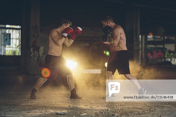 Two boxers fighting in an abandoned factory