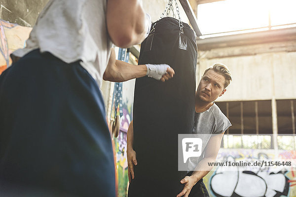 Boxer exercising at punch bag