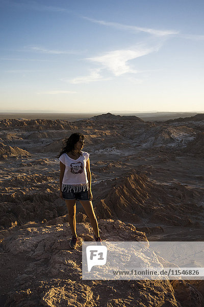 Chile  San Pedro de Atacama  woman standing on rock in the Atacama desert