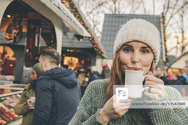 Woman having a hot punch on the Christmas Market