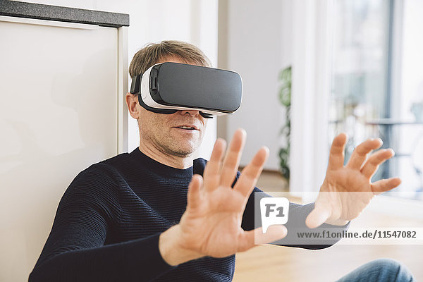 Man wearing virtual reality glasses using his hands