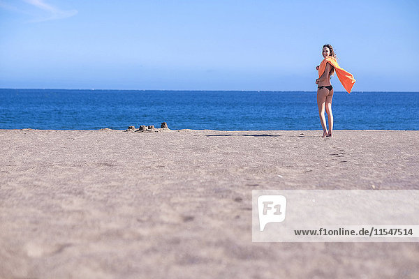 Spain  Tenerife  young woman standing on the beach