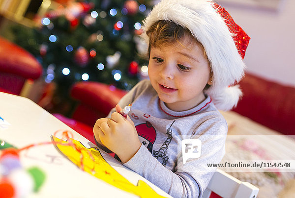 Portrait of little girl tinkering Christmas decoration