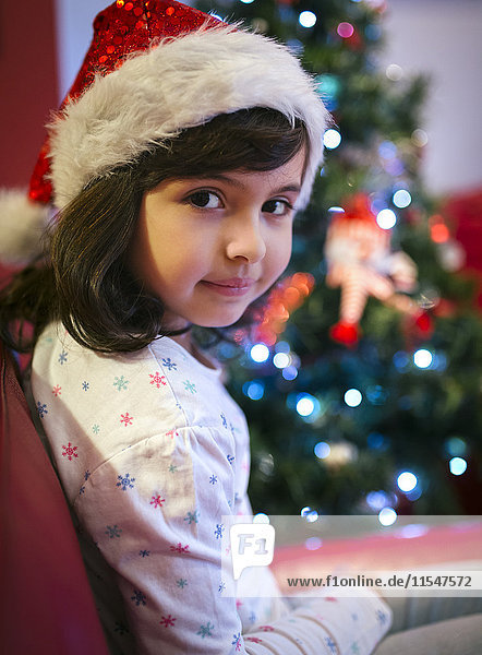 Portrait of smiling little girl wearing Christmas hat
