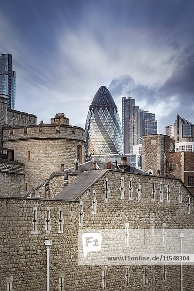 UK  London  view to Swiss Re Tower and other modern buildings with Tower of London in the foreground