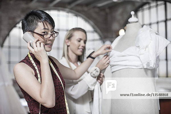 Wedding dress designer talking on phone
